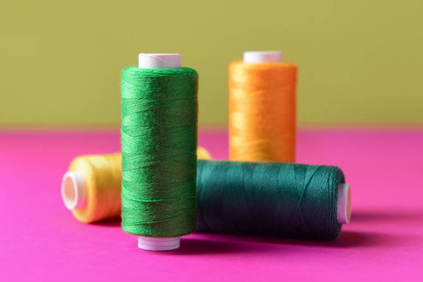 Set of different sewing threads on color table - Photo, Image