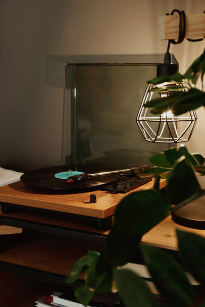 Stylish turntable with vinyl record on table indoors - Fotoğraf, Görsel
