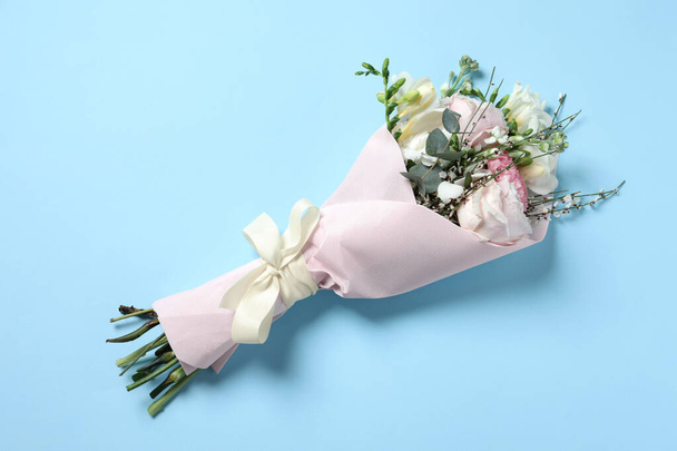 Bouquet of beautiful flowers on light blue background, top view - Foto, immagini
