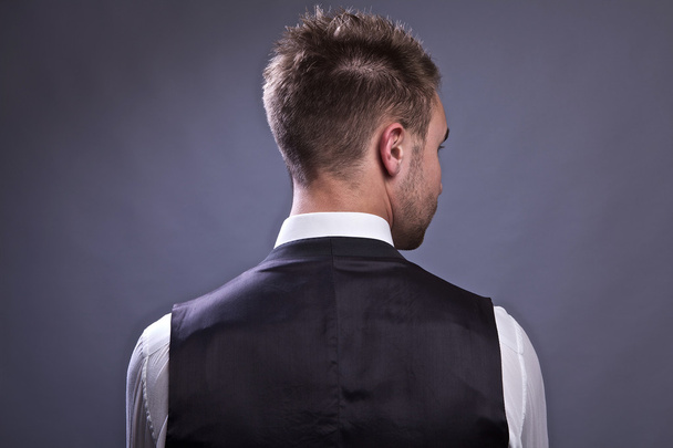 Young business man from back, isolated on gray. - Fotoğraf, Görsel