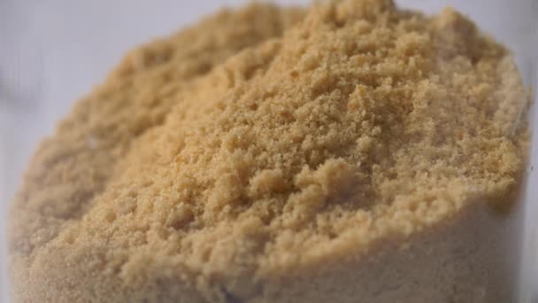 Gros plan sur la texture du sucre brun - Séquence, vidéo