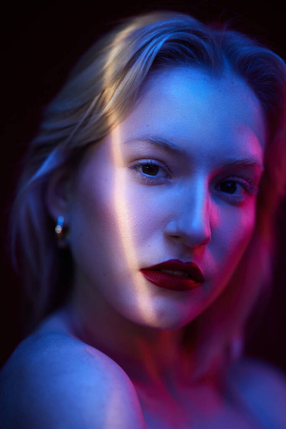 Beauty portrait of a serious blond woman with natural pure skin. Picture taken with photo gels. - 写真・画像