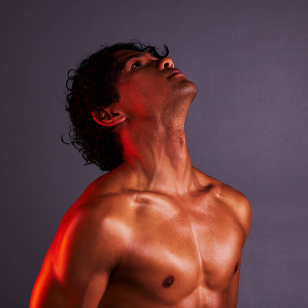 Body, beauty and man profile in a studio with art lighting and thinking with muscles and fitness. Focus, isolated and gray background of an attractive male model with artistic, light and wellness. - Fotó, kép