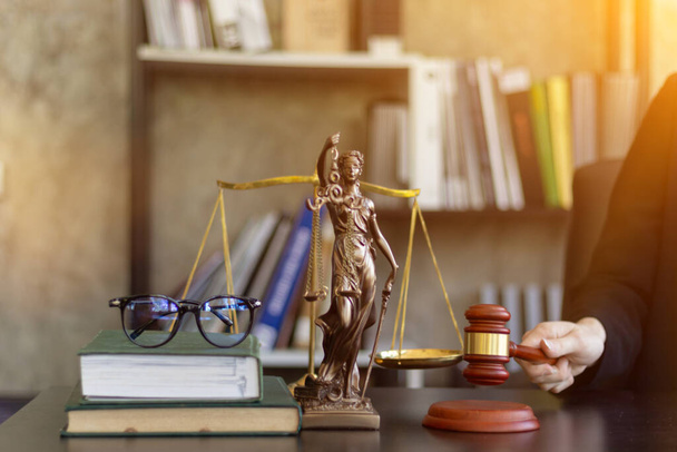 木製の裁判官は、裁判官との司法制度と公民権と社会正義の概念で使用するための正義の象徴としてテーブルの上にギャベル。正義をもって訴訟を判断する法律の概念. - 写真・画像