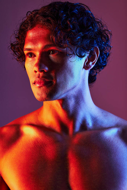 Light, shirtless or man in studio with art lighting and thinking with self care and neon. Focus, isolated and dark background of an attractive male model with artistic, creative and wellness fitness. - Foto, Imagem