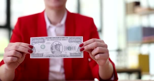 Businesswoman holding bill worth one million dollars in office closeup 4k movie slow motion. Success and wealth concept - Footage, Video