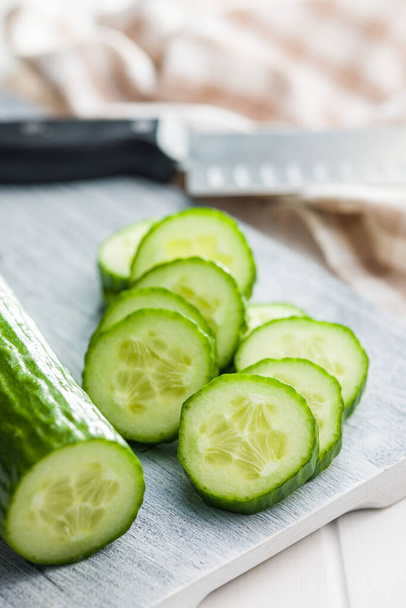 Sliced fresh green cucumber on the cutting board. - Photo, image