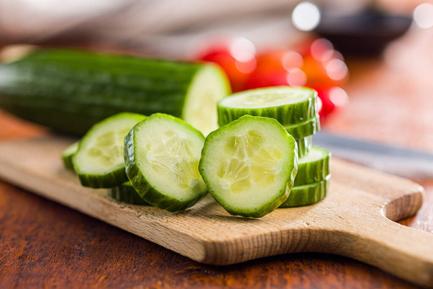 Sliced fresh green cucumber on the cutting board. - Foto, imagen