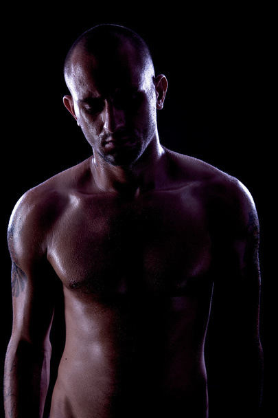 Strong athletic man on black background - Foto, Bild