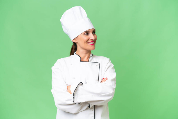 Middle-aged chef woman over isolated background looking side - Photo, Image
