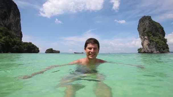 Man swims in lagoon water - Footage, Video