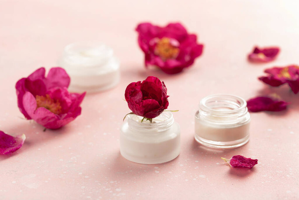 skincare products and dog rose flowers. natural cosmetics for home spa treatment - Fotó, kép