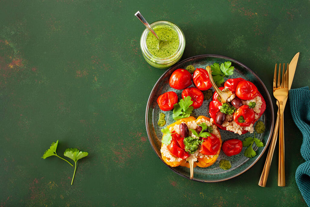 stuffed bell peppers with quinoa tomatoes olives and herb sauce chimichurri - Photo, image