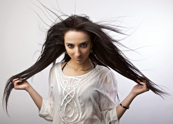 Armenian girl with healthy beautiful long hair in motion. Fashion look. - Photo, image