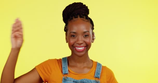 Salute, portrait and black woman with deaf hearing aid in greeting sign language isolated in a yellow studio background. Smile, welcome and young female with a listening disability doing hand gesture. - Footage, Video