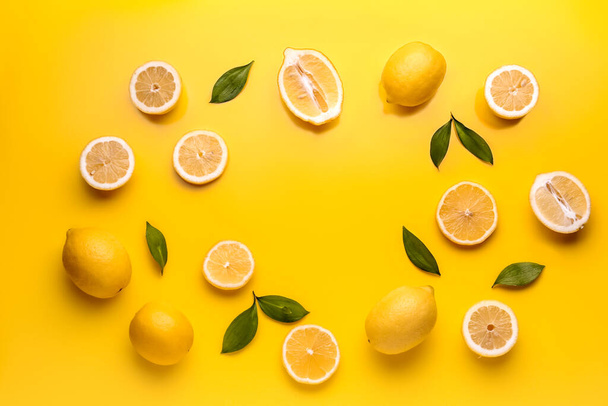 Frame made of fresh lemons on yellow background - Photo, image