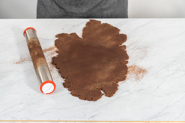Rolling cookie dough with an adjustable rolling pin on the counter. - Photo, Image
