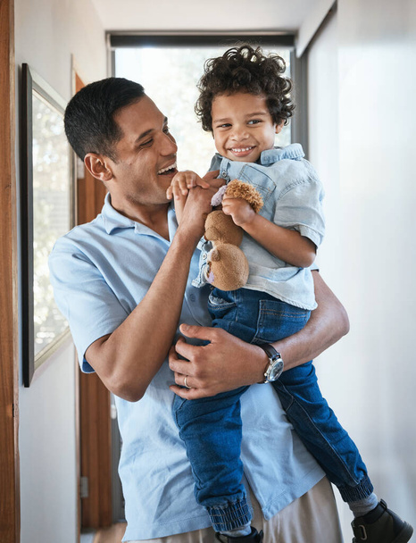 Love, father and son with a hug, smile and bonding at home, cheerful and quality time. Family, male parent and boy with happiness, kid and child in the living room, joyful and embrace with affection. - Photo, Image