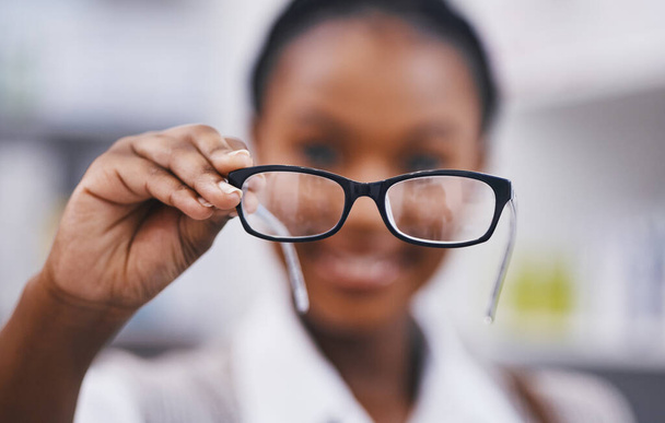 Vision, eye care and woman with glasses hand, clinic for eye exam and help for poor sight with health and wellness. Eyesight, wellness and girl holding designer brand frame and lens for healthy eyes - 写真・画像