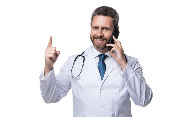 physician online with raised finger on background. photo of physician online with phone. physician online isolated on white. physician online in studio. - Fotografie, Obrázek
