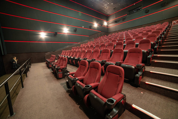 empty cinema hall with red seats and chairs - Zdjęcie, obraz