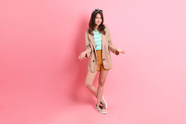 The young adult Asian woman with casual clothes on the pink background. - Fotó, kép