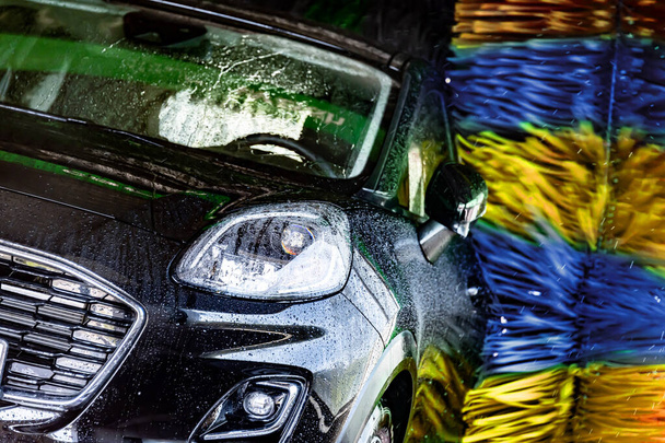 A motorcar in an automatic car wash. - Photo, Image