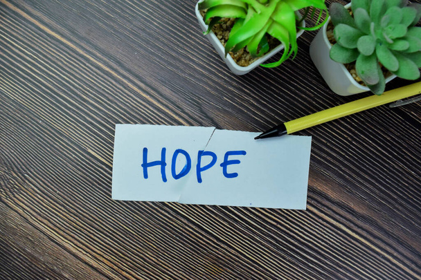 Concept of Hope write on sticky notes isolated on Wooden Table. - Photo, Image