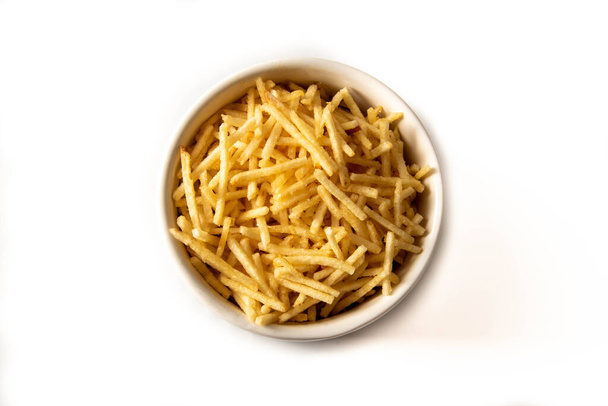 Potato straw or potato straw in a bowl isolated over white background. top view - Photo, Image