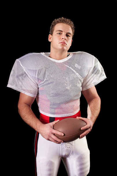 American football player. Studio shot over black. - Фото, изображение