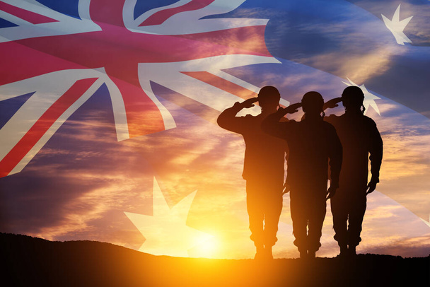 Silhouettes of soldiers saluting on background of Australia flag and the sunset or the sunrise background. Anzac Day. Remembrance Day. - Fotografie, Obrázek
