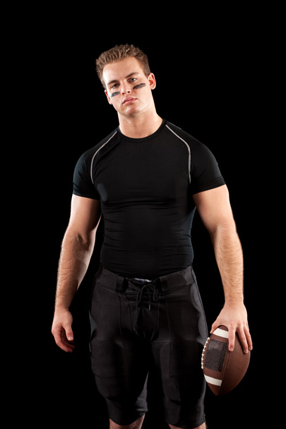 American football player. Studio shot over black. - Zdjęcie, obraz