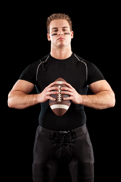 American football player. Studio shot over black. - Foto, Bild