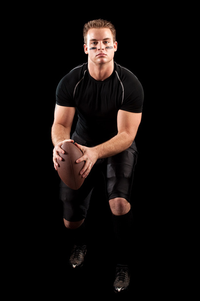 American football player. Studio shot over black. - Фото, зображення