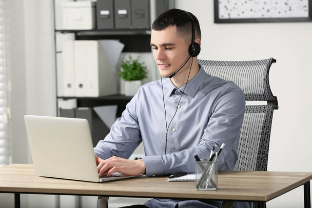 Hotline operator with headset working in office - Photo, image