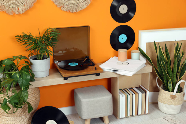 Stylish turntable with vinyl record on console table in cozy room - Φωτογραφία, εικόνα