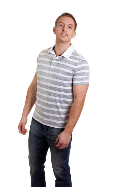 Young man in striped shirt and jeans. Studio shot over white. - Valokuva, kuva