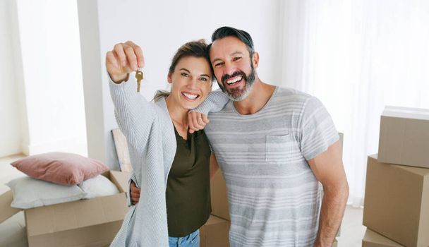 We have a place to call our own. a couple holding the key to their new home - Zdjęcie, obraz