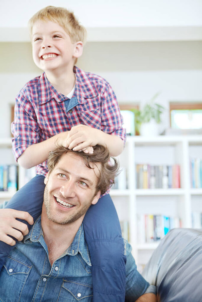 Am Wochenende mit Papa abhängen. ein kleiner Junge sitzt auf den Schultern seines Vaters - Foto, Bild