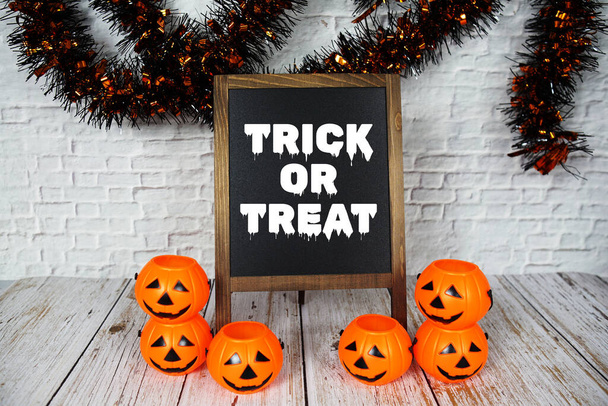 Trick or Treat text message written on blackboard with Halloween decoration - Photo, Image