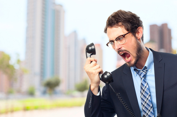 young crazy businessman shouting at phone - Valokuva, kuva