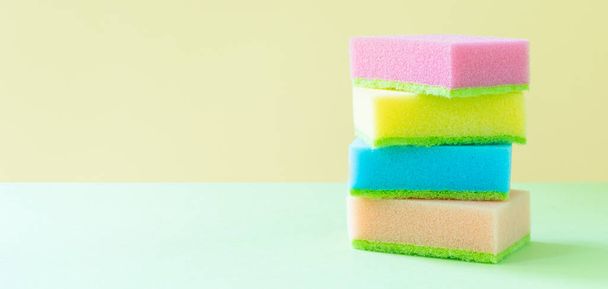Cleaning concept - colorful dishwashing sponges on bright background, copy space - Fotó, kép