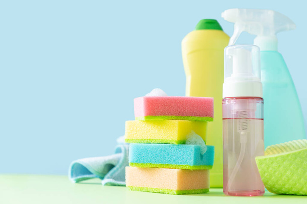 Cleaning concept - cleaning supplies on pastel yellow background, copy space - Foto, Bild