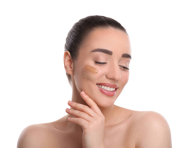 Woman with swatches of foundation on face against white background - Foto, Imagem
