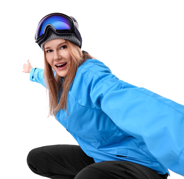 Beautiful woman in ski goggles taking selfie on white background - Фото, изображение