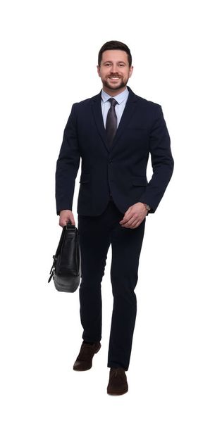 Handsome bearded businessman in suit with briefcase on white background - Фото, изображение