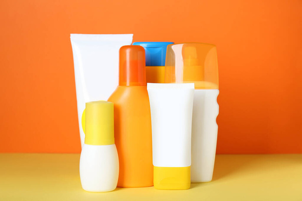 Set of different suntan products on color background - Fotó, kép