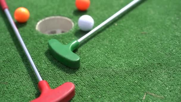 Close-up of miniature golf hole with bat and ball. - Footage, Video