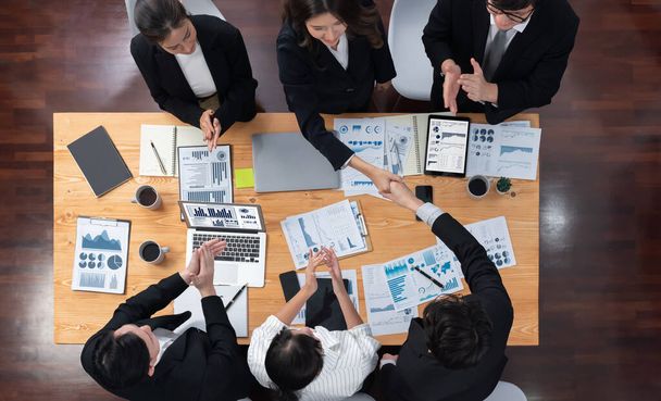 Top-view business team of financial data analysis meeting with business intelligence, report paper and dashboard on laptop for marketing strategy. Business people working together in office of harmony - Foto, imagen