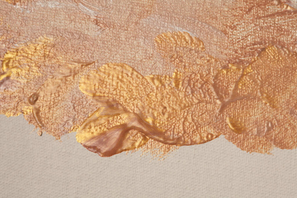 Oil and acrylic smear painting blot on canvas wall. Abstract gold, bronze, beige color stain brushstroke texture background. - Fotografie, Obrázek